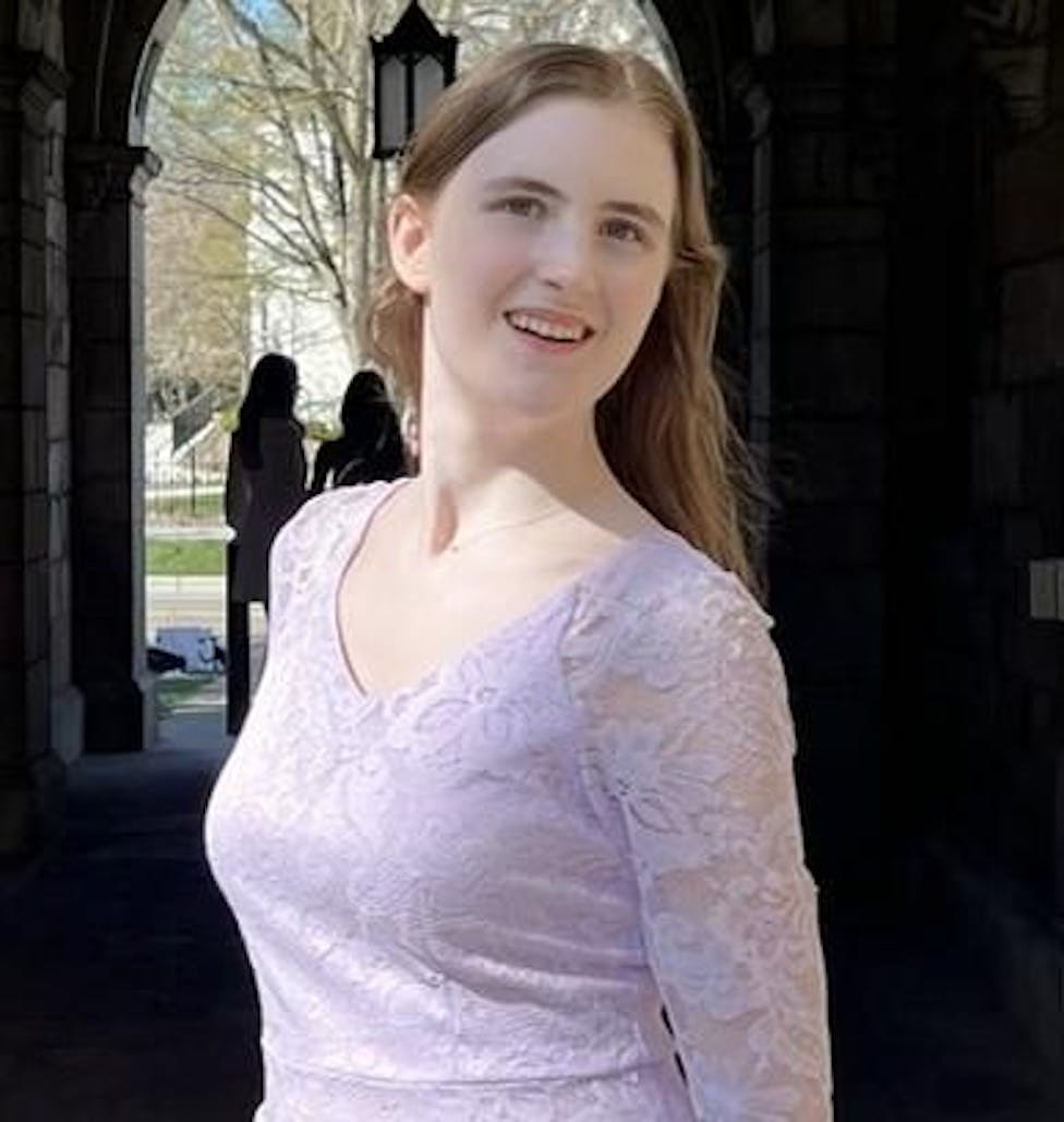 Headshot of Allie Beecher, outdoors, from the waist-up.