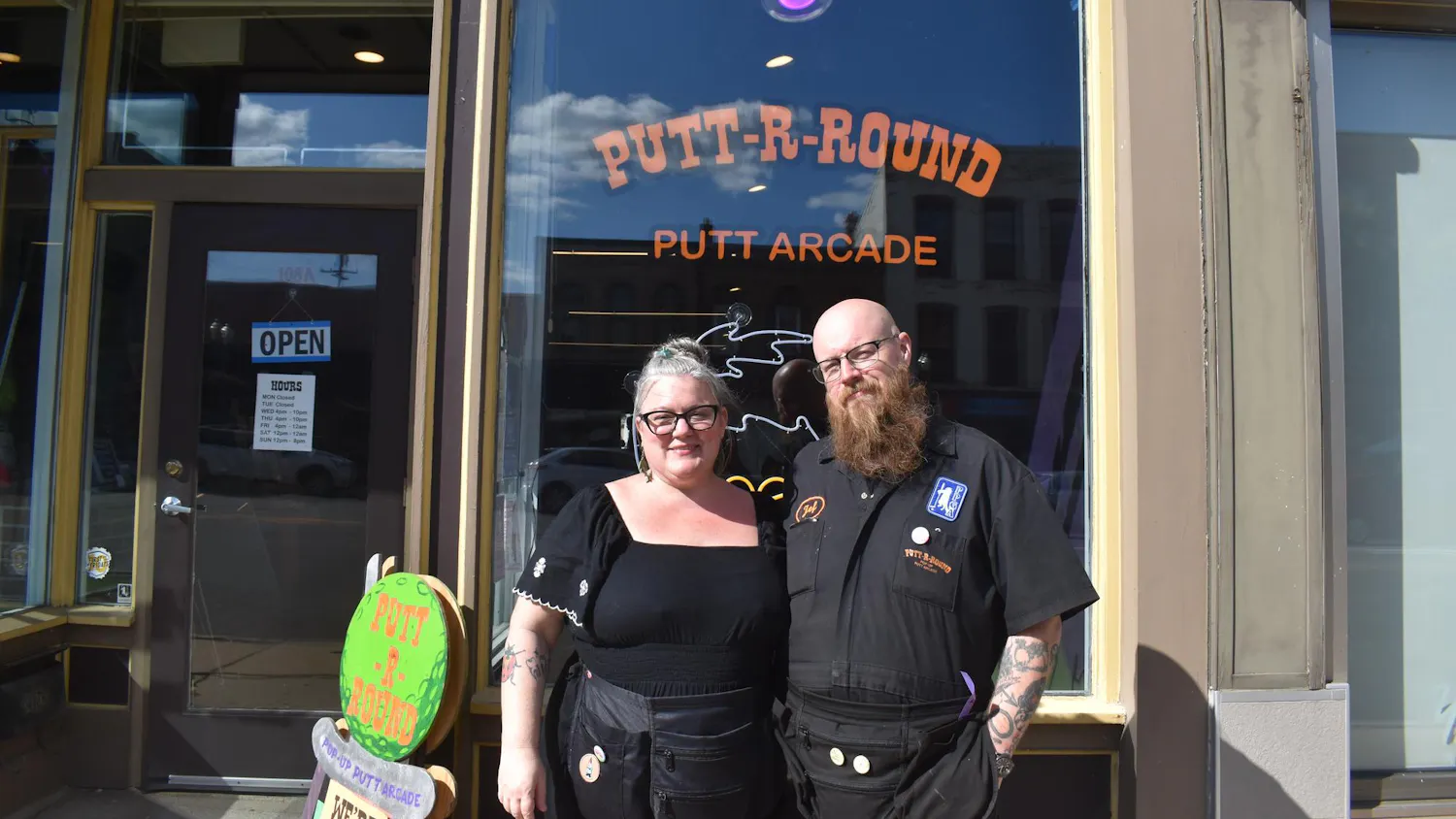 The co-founders Jane Weber and Jef Jenkins standing in front of their Putt-R-Round business in Ypsilanti