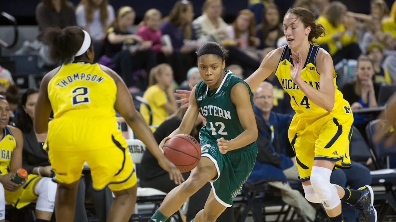 Eastern Michigan guard Micah Robinson drves past Michigan players to the basket in the Eagles 81-52 loss to Michigan Monday afternoon at Crisler Arena.