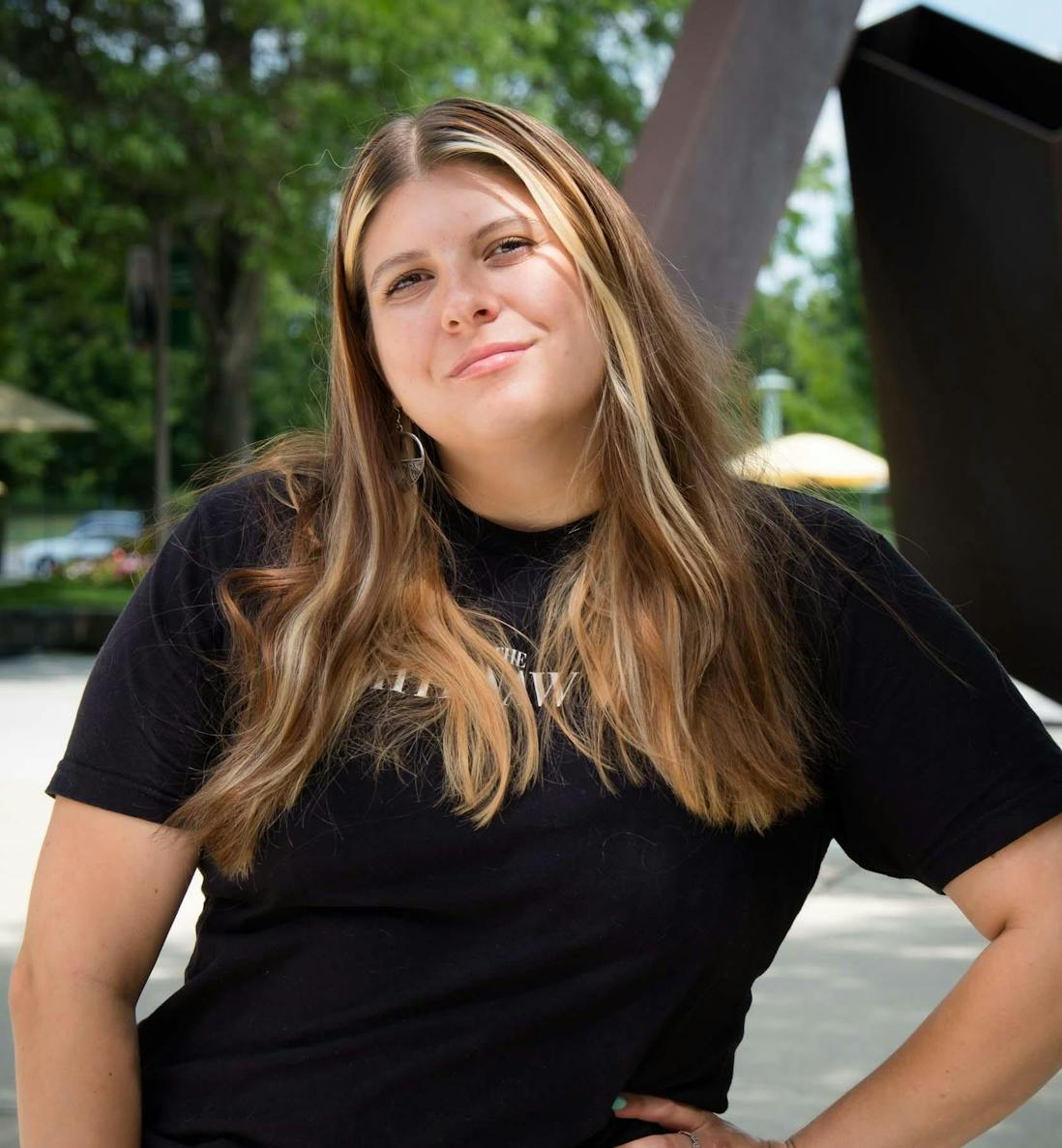 Outdoor headshot of Lilly Kujawski, from the waist-up.