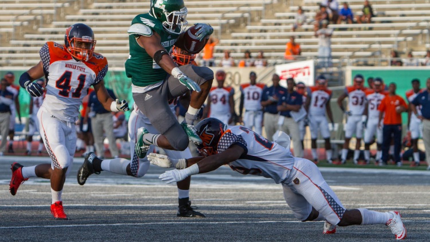 Eastern Michigan running back Ryan Brumfield (22) leaps over a Morgan State player for a touchdown in the Eagles 31-28 victory over Morgan State Saturday night in Ypsilanti.