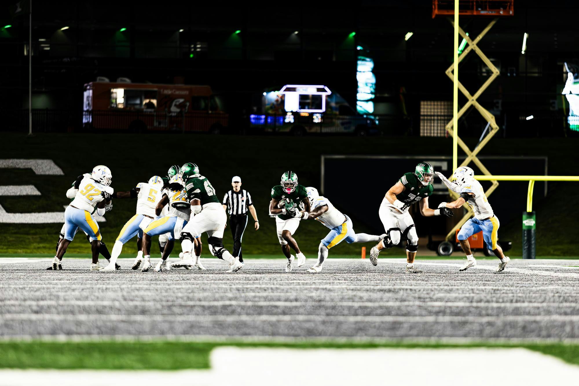 An Eastern Michigan running back shakes off an LIU tackler to exploit the open gap created by his offensive line. 