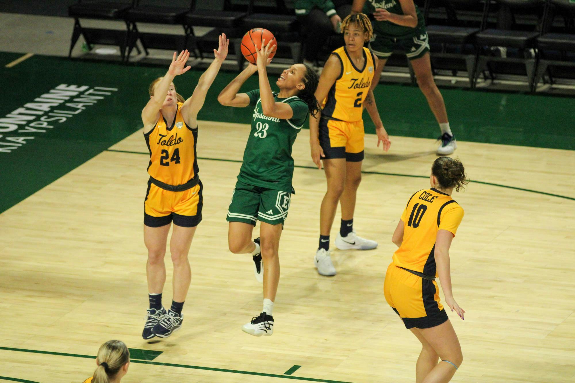 EMU player #23 Hill, jumping to take a shot.