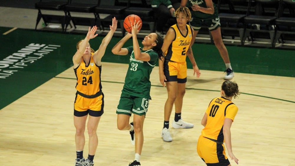 EMU player #23 Hill, jumping to take a shot.