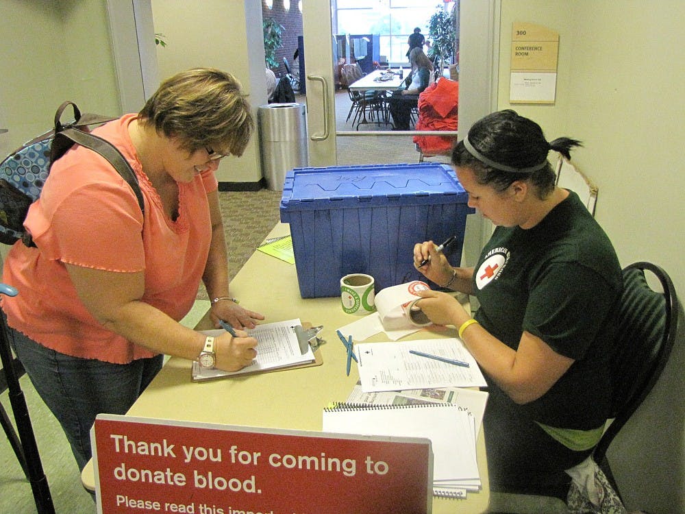 Katie Turner, Sr. registers fellow student Suzanne Battaglia, Sr. at the Student Center Blood Drive last Monday.