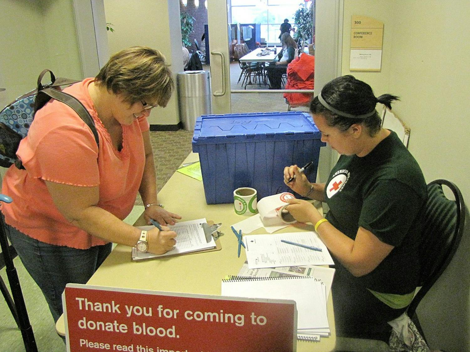 Katie Turner, Sr. registers fellow student Suzanne Battaglia, Sr. at the Student Center Blood Drive last Monday.
