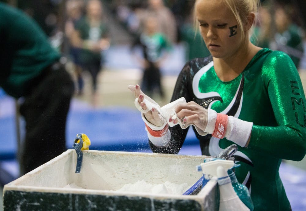 Eastern Michigan junior Nikki Paterson gets ready to perform on the bars in the Eagles 195.925-194.600 loss to Central Michigan Friday night.