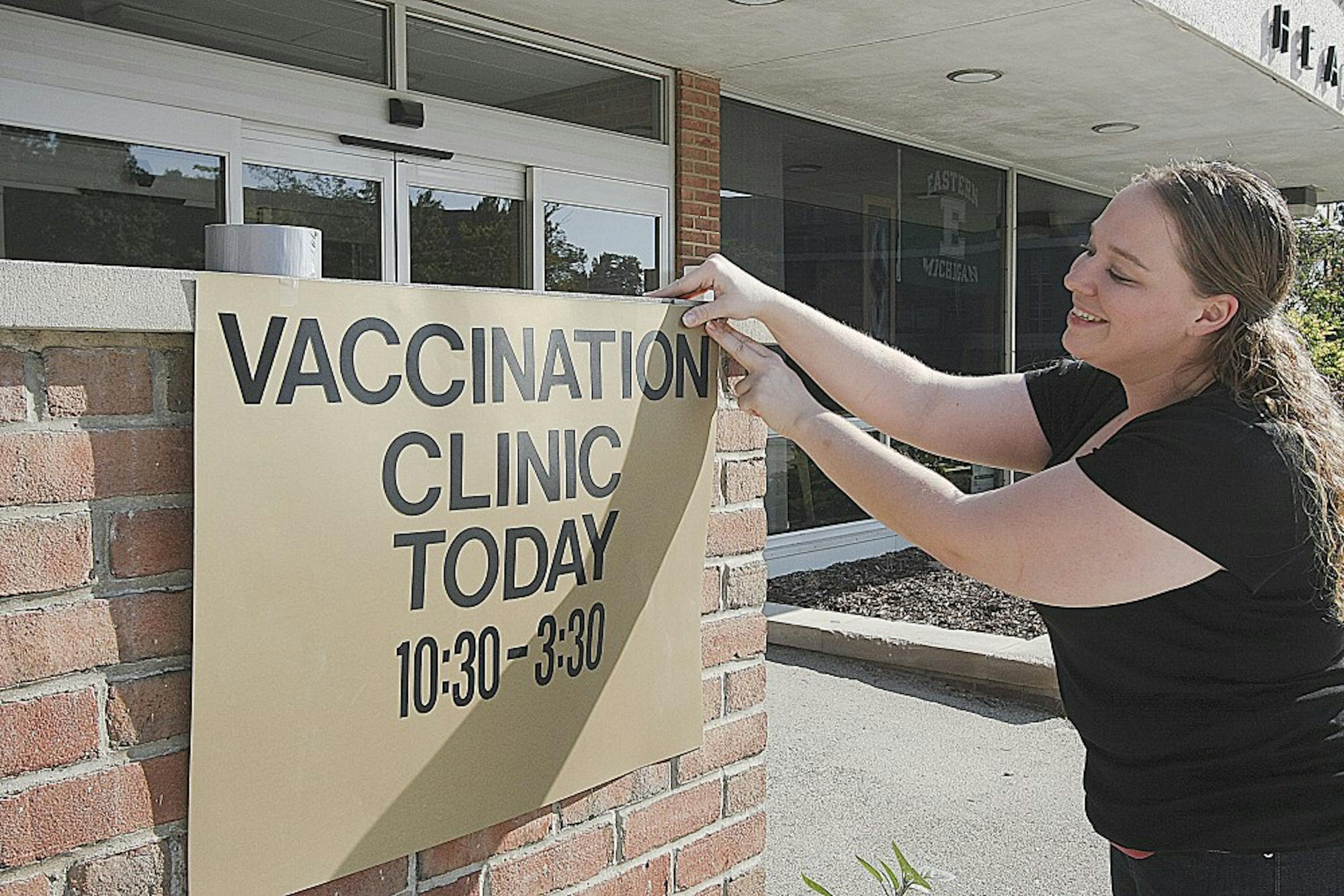 Amanda Lefled, the director of busines opperations at Snow Health Center, is shown here posting a sign with information about move in day vaccination times.