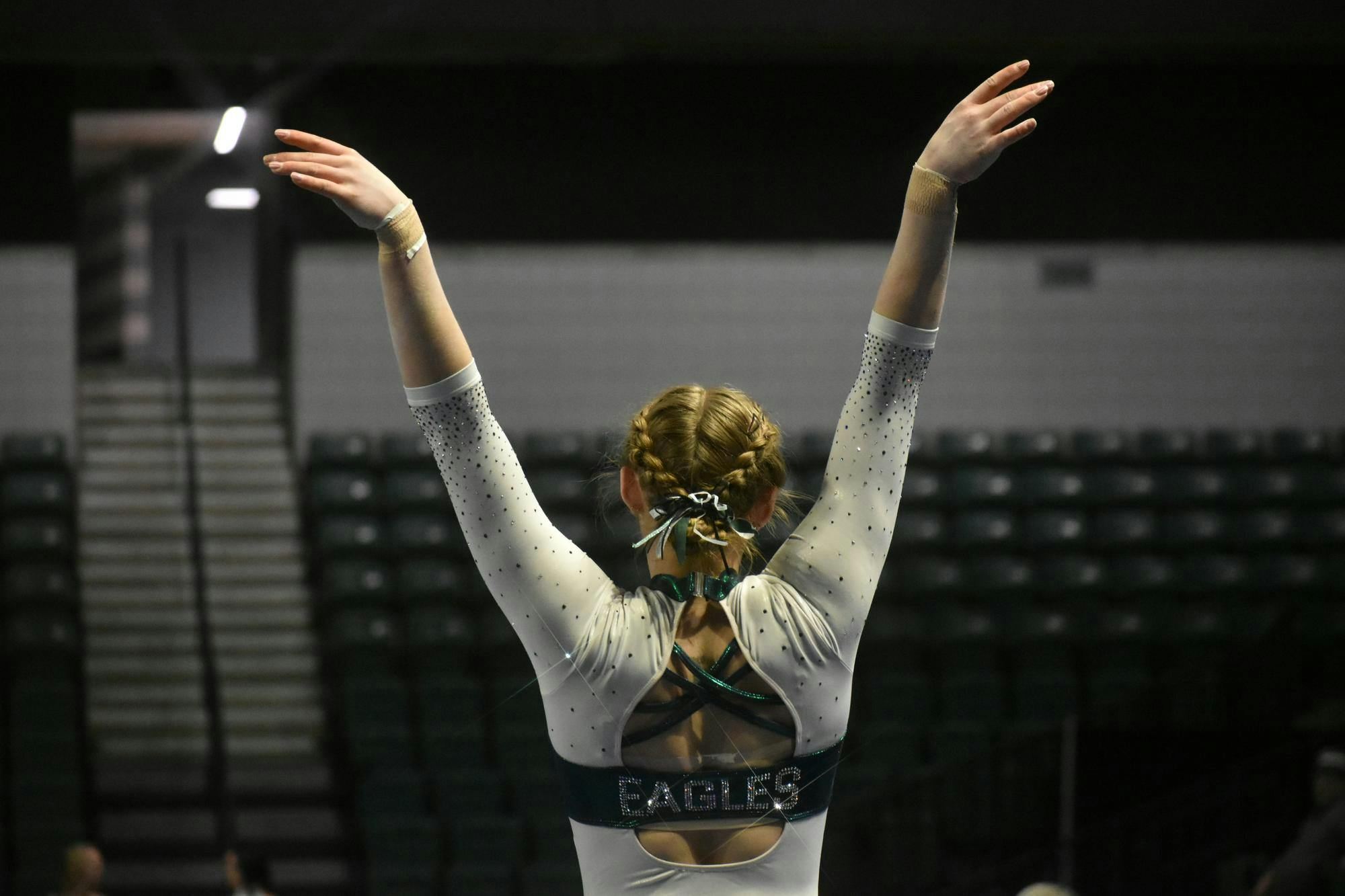 Gymnast Georgie Slack salutes to the stands after completing a vault.