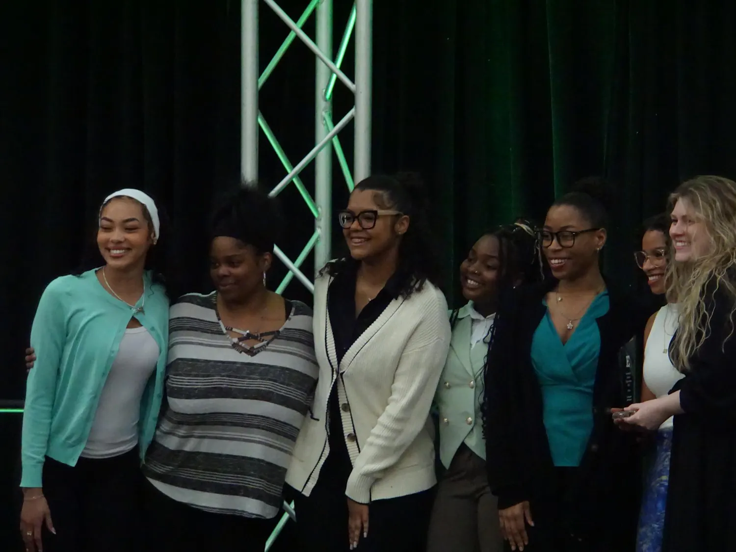 The You Beautiful Black Women Organization poses on stage with their award.