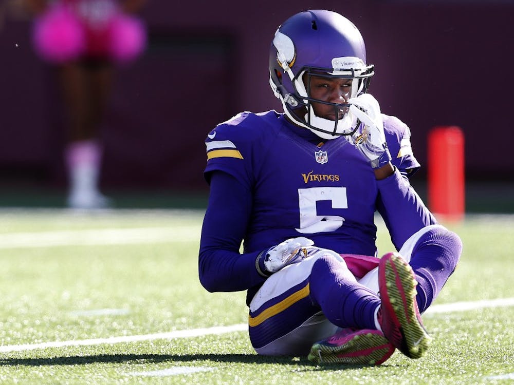 Minnesota Vikings quarterback Teddy Bridgewater (5) sits on the ground after being pressured and hit during the fourth quarter on Sunday, Oct. 12, 2014, at TCF Bank Stadium in Minneapolis. (Carlos Gonzalez/Minneapolis Star Tribune/MCT)