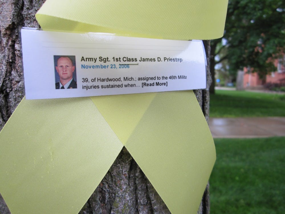 Students hang ribbons in memory of fallen veterans