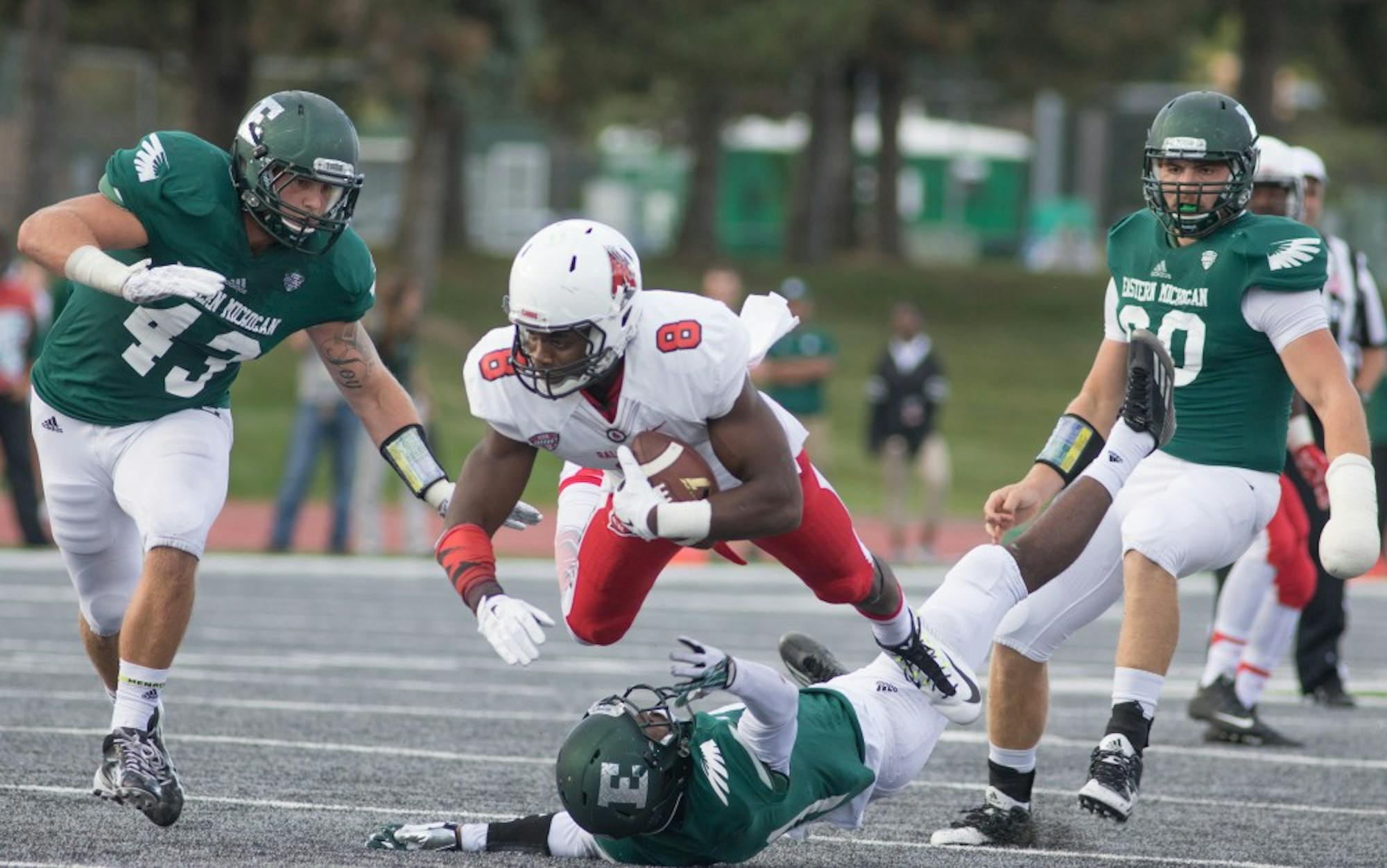 Ball State wide receiver Jordan Williams dives over an defender against Eastern Michigan Saturday afternoon in Ypsilanti, Mich. The Cardinals defeated the Eagles 28-17.