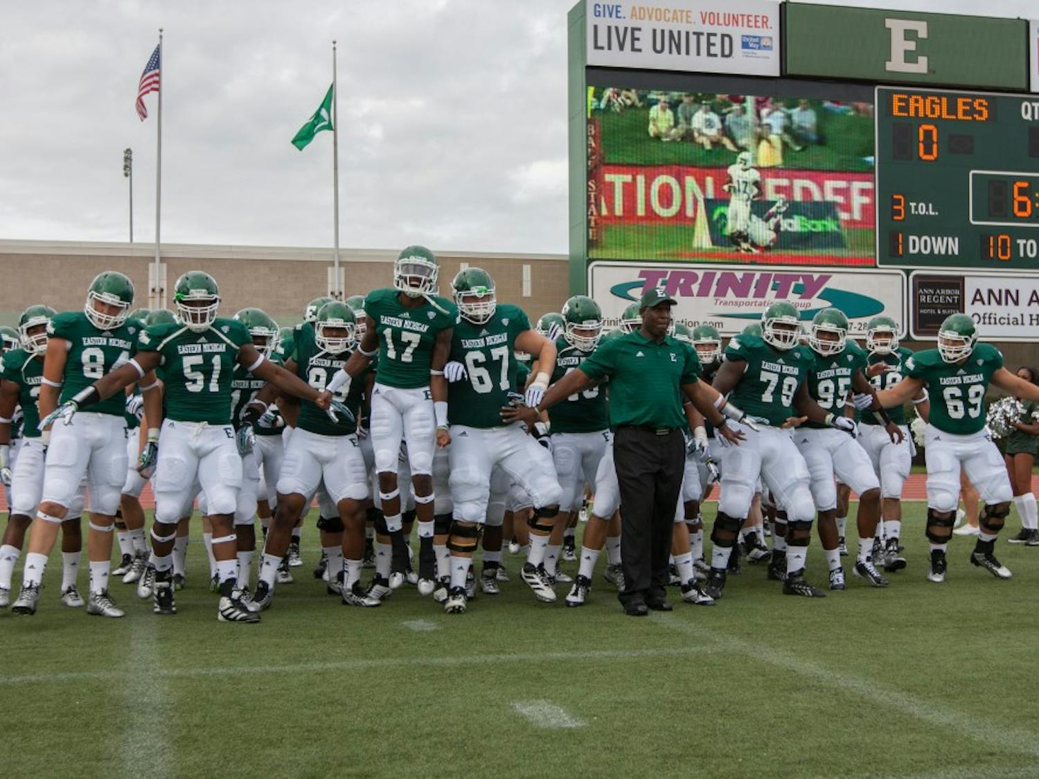 EMU Head Coach Ron English leads his team onto the field vs. Howard Saturday night at Rynearson Stadium in Ypsilanti.