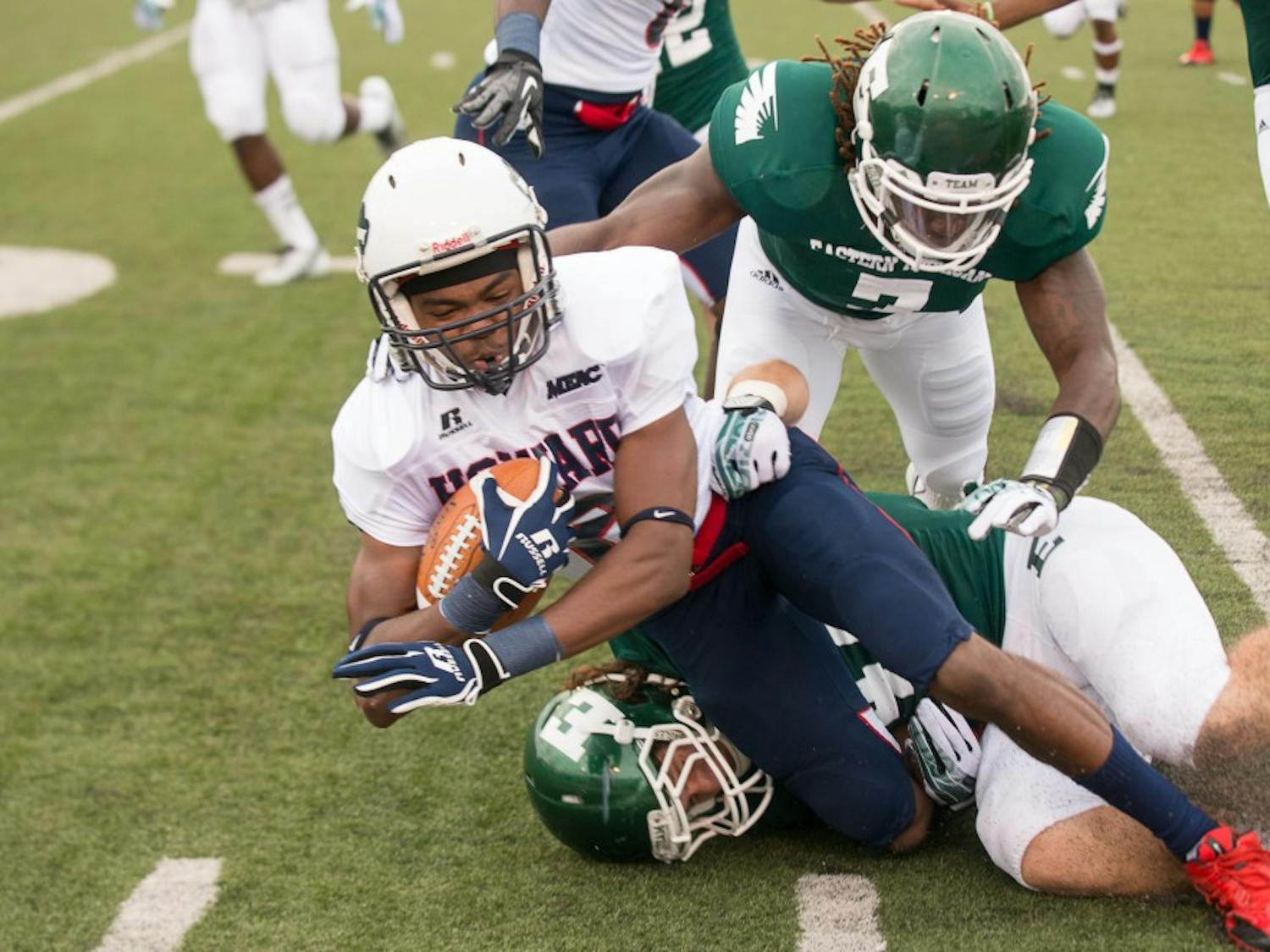 Howard reciever Matthew Colvin gets tackled by a pair of Eagles during the Bison's game a gainst Eastern Michigan on August 31 at Rynearson Stadium.