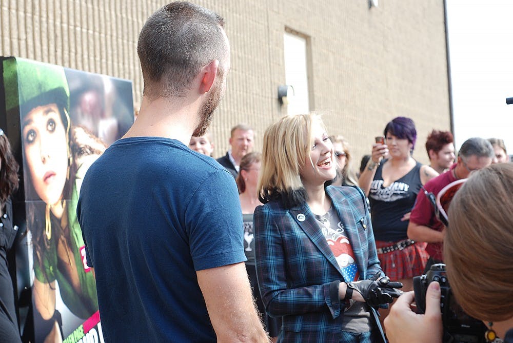 	Drew Barrymore laughs with reporters outside of the Bonaventure Skating Rink in Farmington Hills.