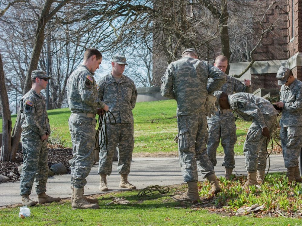 EMU ROTC Students secure their rope harnesses before heading to the roof of Roosevelt Hall on Thursday, April 17, 2014.