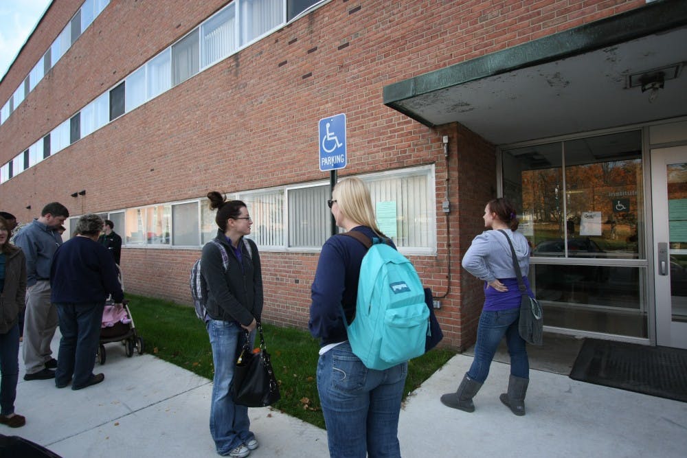 	Students and staff line up behind Show Health Center on Wenesday in order to recieve vaccinations in groups of fives. EMU is only offering vaccinations for those deemed high risk patients due to the shortage of vaccines available. High risk individuals include pregnant women, those with chronic pulmonary disorders, health care workers, EMS/first responders and those who care for or live with infants 