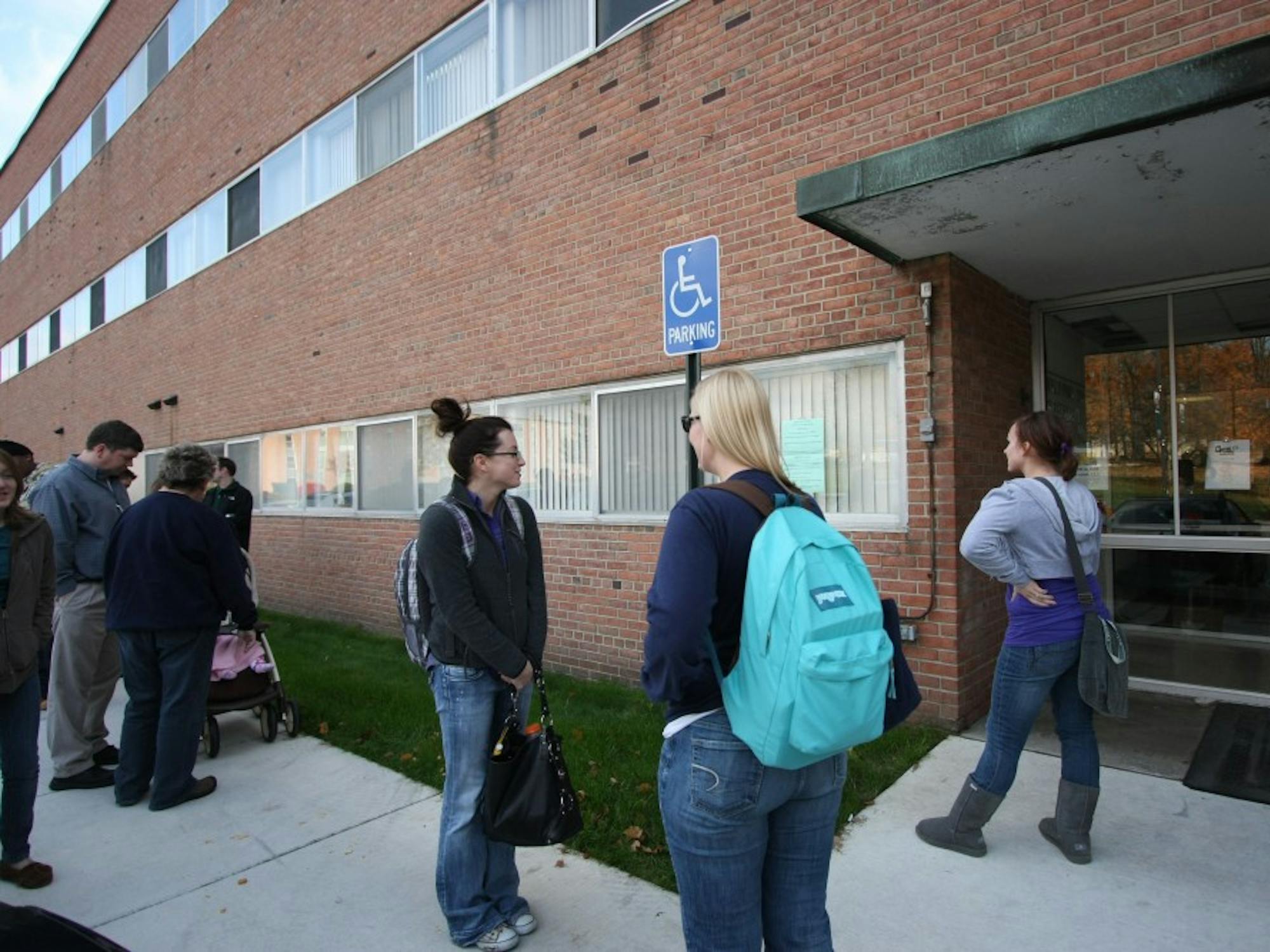 	Students and staff line up behind Show Health Center on Wenesday in order to recieve vaccinations in groups of fives. EMU is only offering vaccinations for those deemed high risk patients due to the shortage of vaccines available. High risk individuals include pregnant women, those with chronic pulmonary disorders, health care workers, EMS/first responders and those who care for or live with infants 