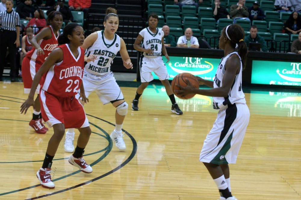 	Eastern Michigan University guard Sydney Huntley (right) looks to teammates Cassie Schrock (22) and Tavelyn James (24) for support during their home game versus Cornell University on Friday. The Eagles won 66-41.