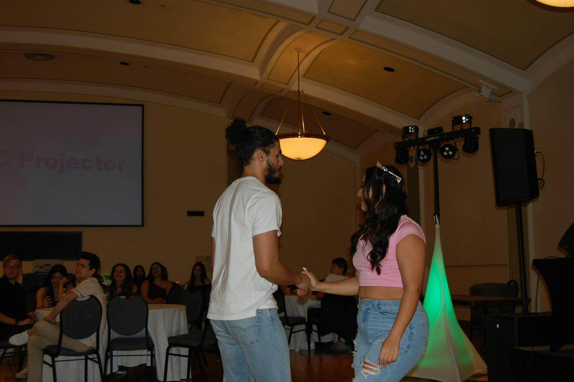 Eastern Michigan University freshman Estivin Lebron escorts Emma Moore to the dance floor.