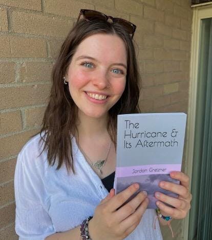 Jordan Gretzner holding her novel 