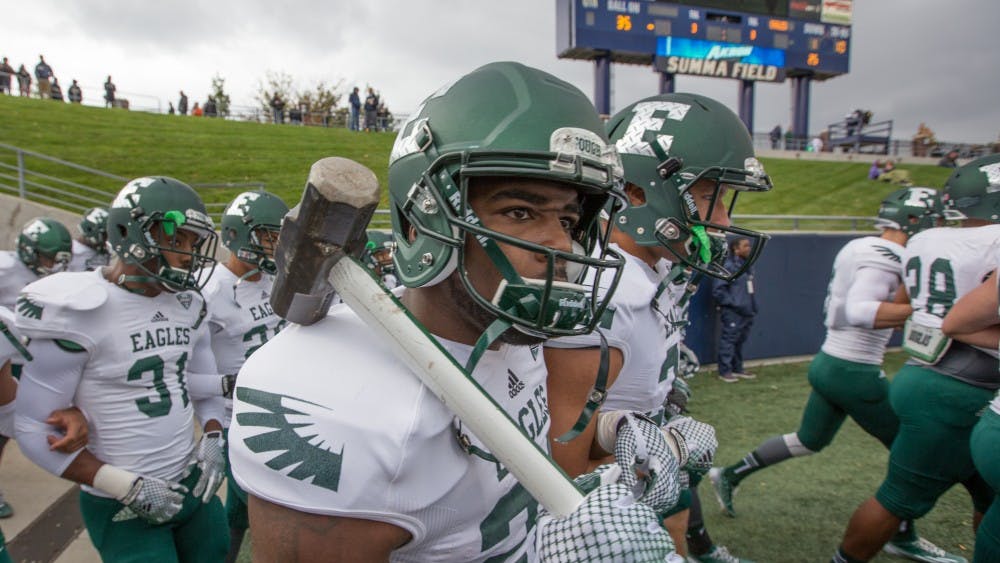 An Eastern Michigan player carries the sledgehammer onto the field before the Eagles took on Akron Saturday afternoon in Akron, Ohio.