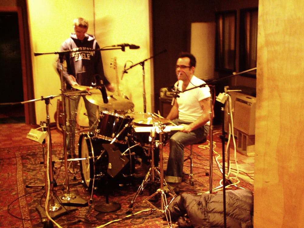 Joe Csicsila, left, and Jim Knapp rehearse last month while prepping for the release of their new album “Down and In.”  
