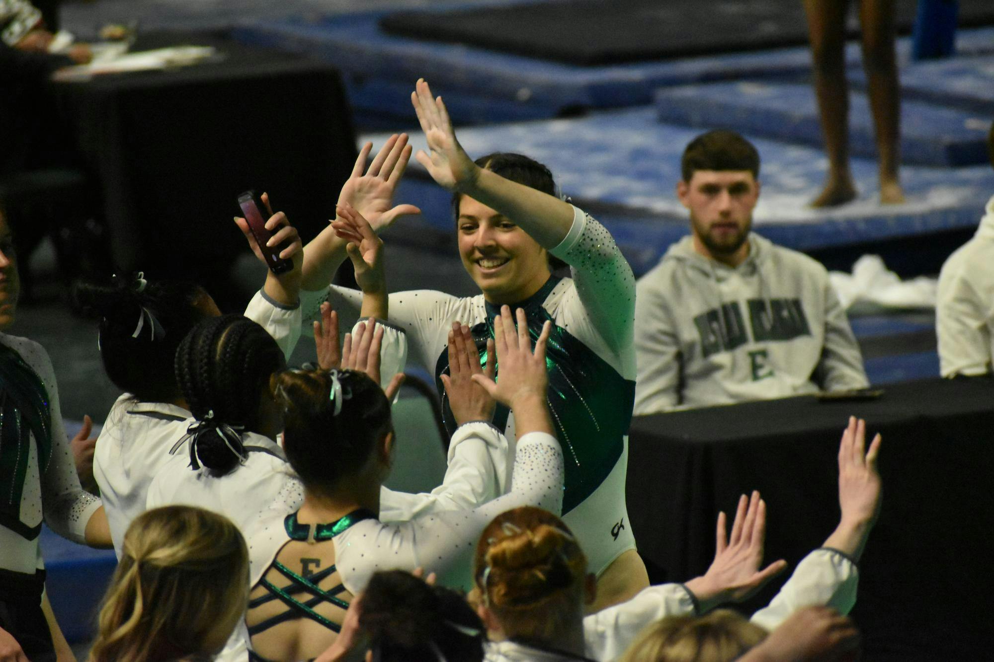Gymnast Macy Nihart high fives her teammates.