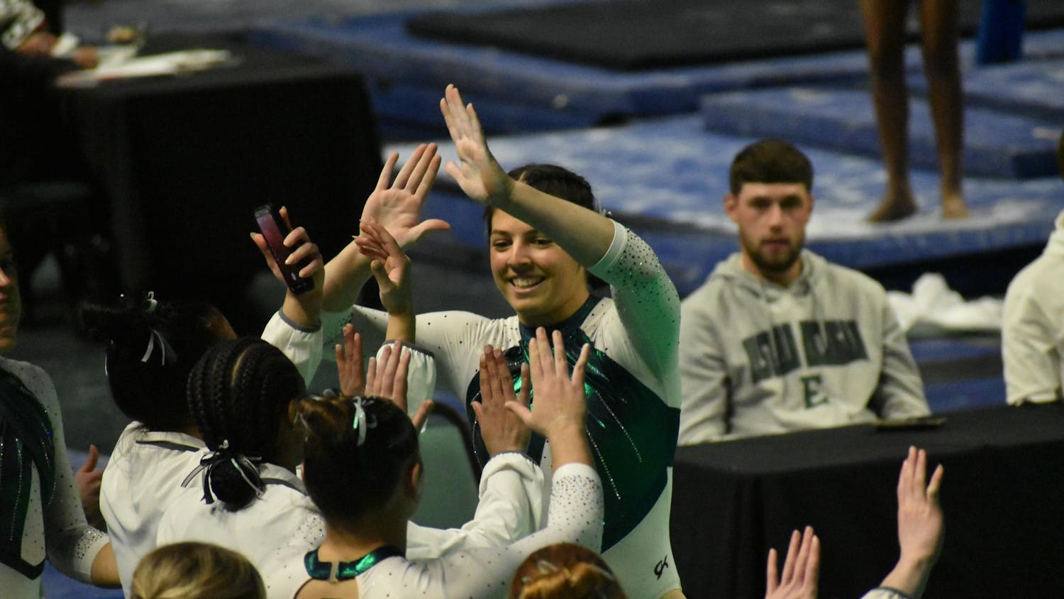 Gymnast Macy Nihart high fives her teammates.