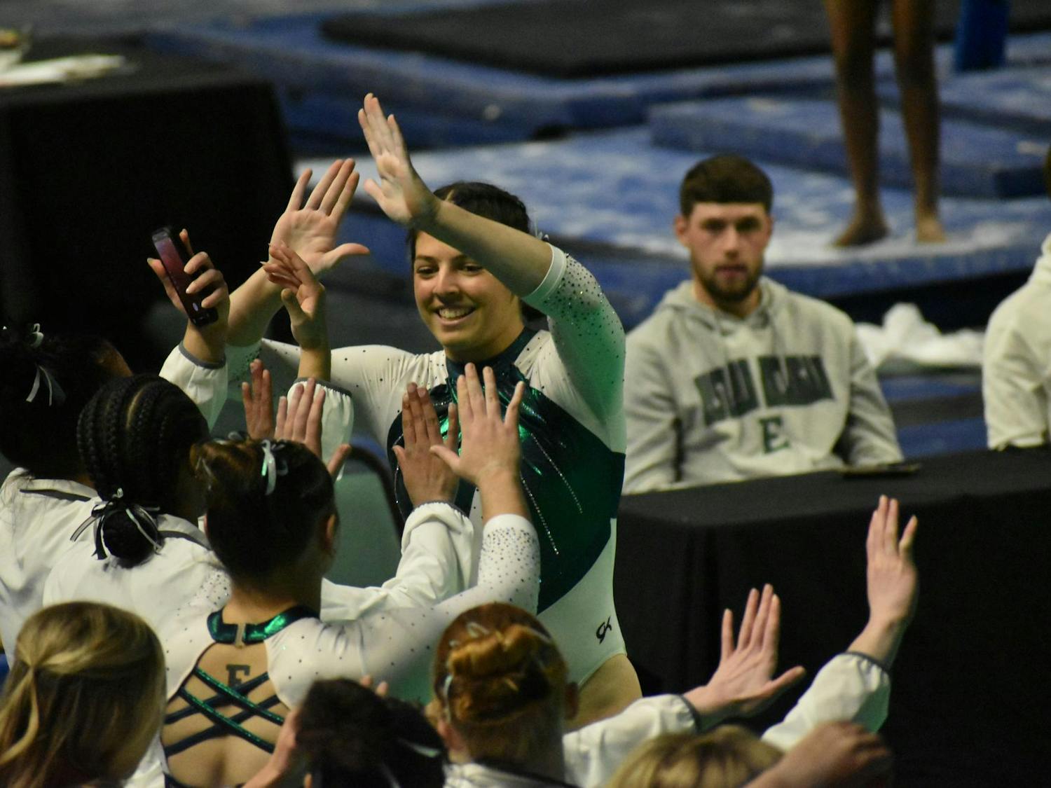 Gymnast Macy Nihart high fives her teammates.