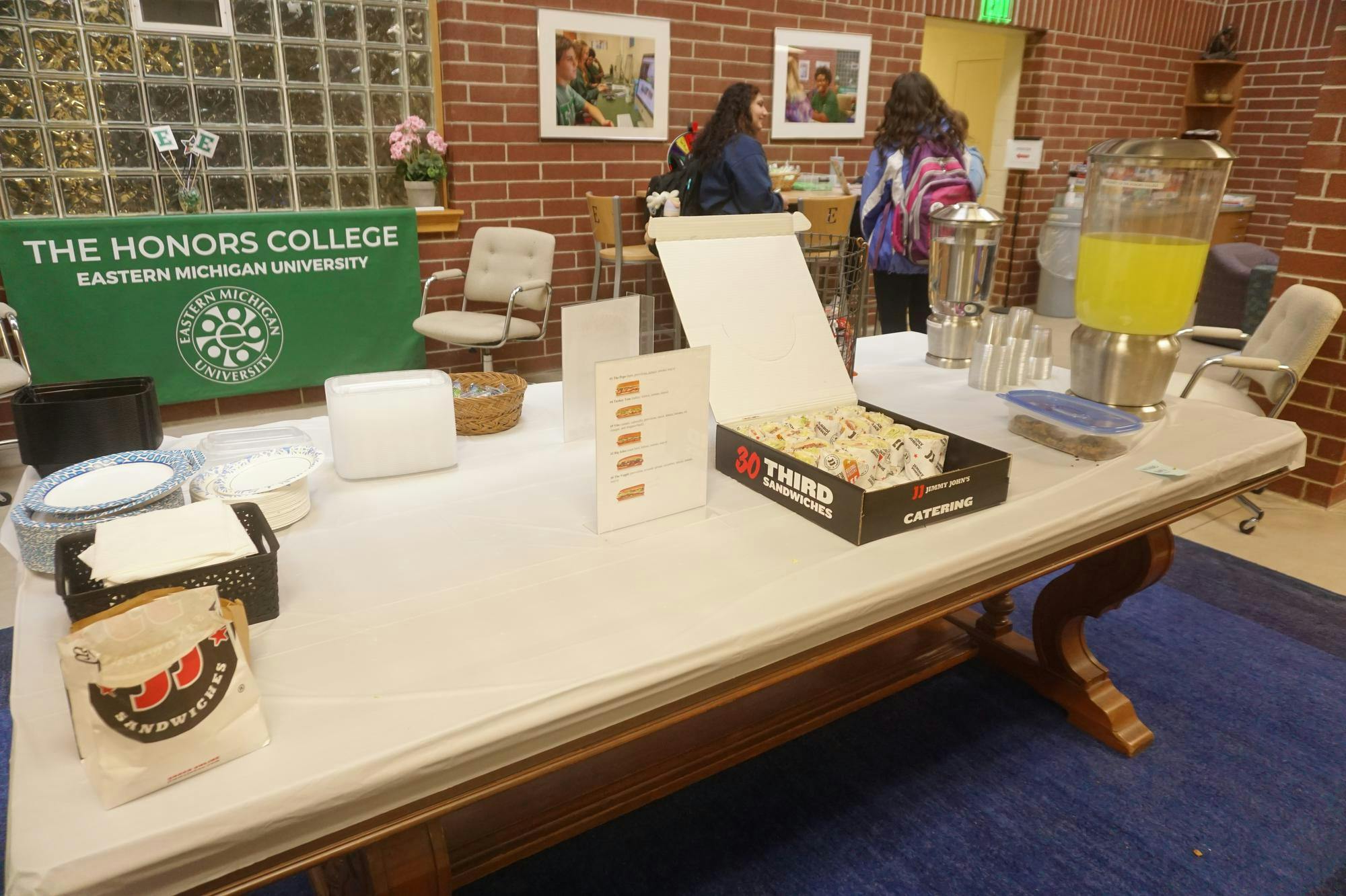 A view of a box of sandwiches and some lemonade and water for students to help themselves. 