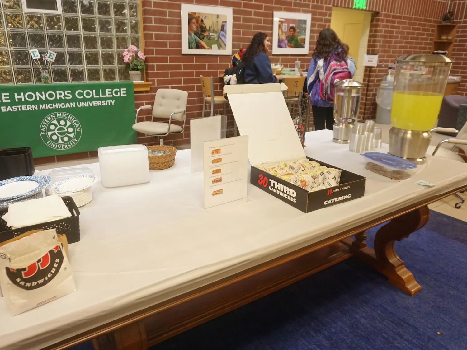 A view of a box of sandwiches and some lemonade and water for students to help themselves.