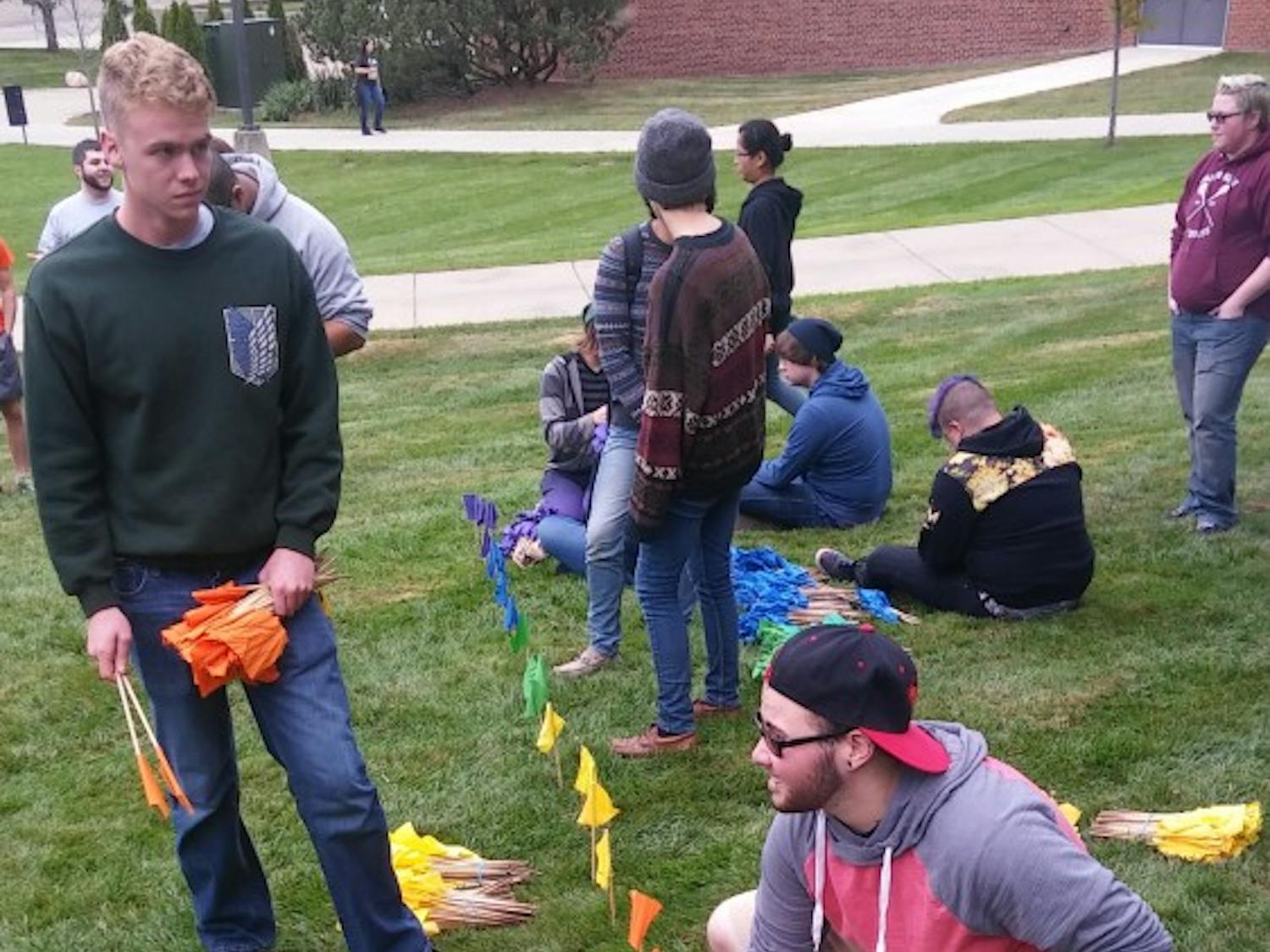 Students lined individual flags to make one big flag on the lawn outside Pray-Harrold.