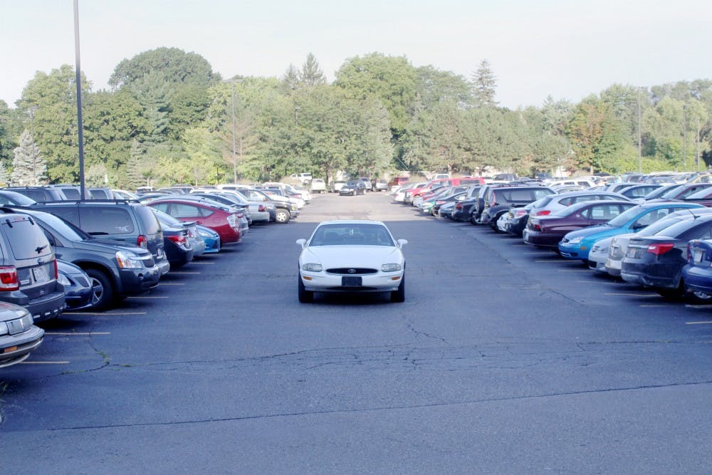	A driver stalls in a lot on campus waiting for spots to open up.