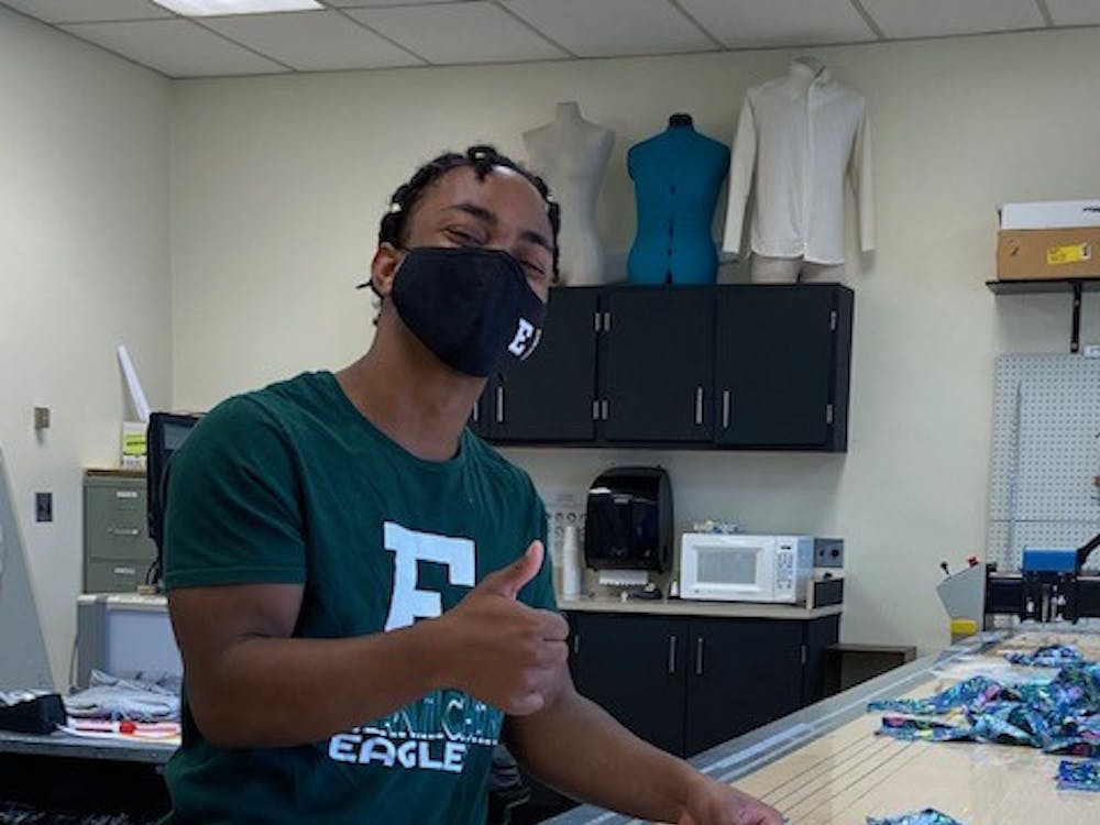Darryl Phillips, a fashion marketing and innovation major, and Ashanti Elliot, a fashion marketing and innovation student cutting the fabric into squares to be later donated to the Preemie Pals Project to be made into quilts. (Photo Courtesy of Dr. Julie Becker)