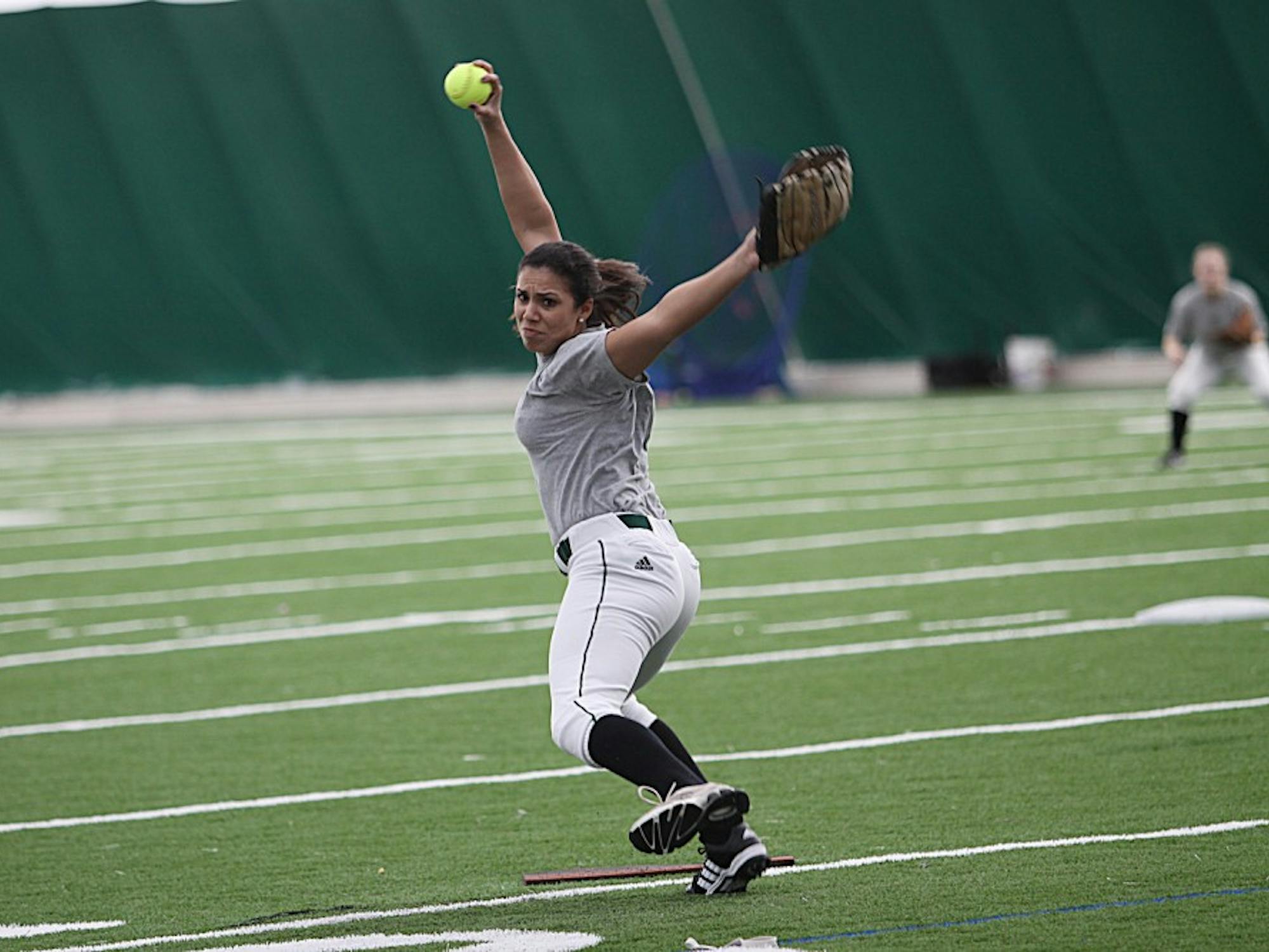 Senior Jaclyn Caro warms up for the upcoming softball season. Caro finished with a 1-5 record last season.
