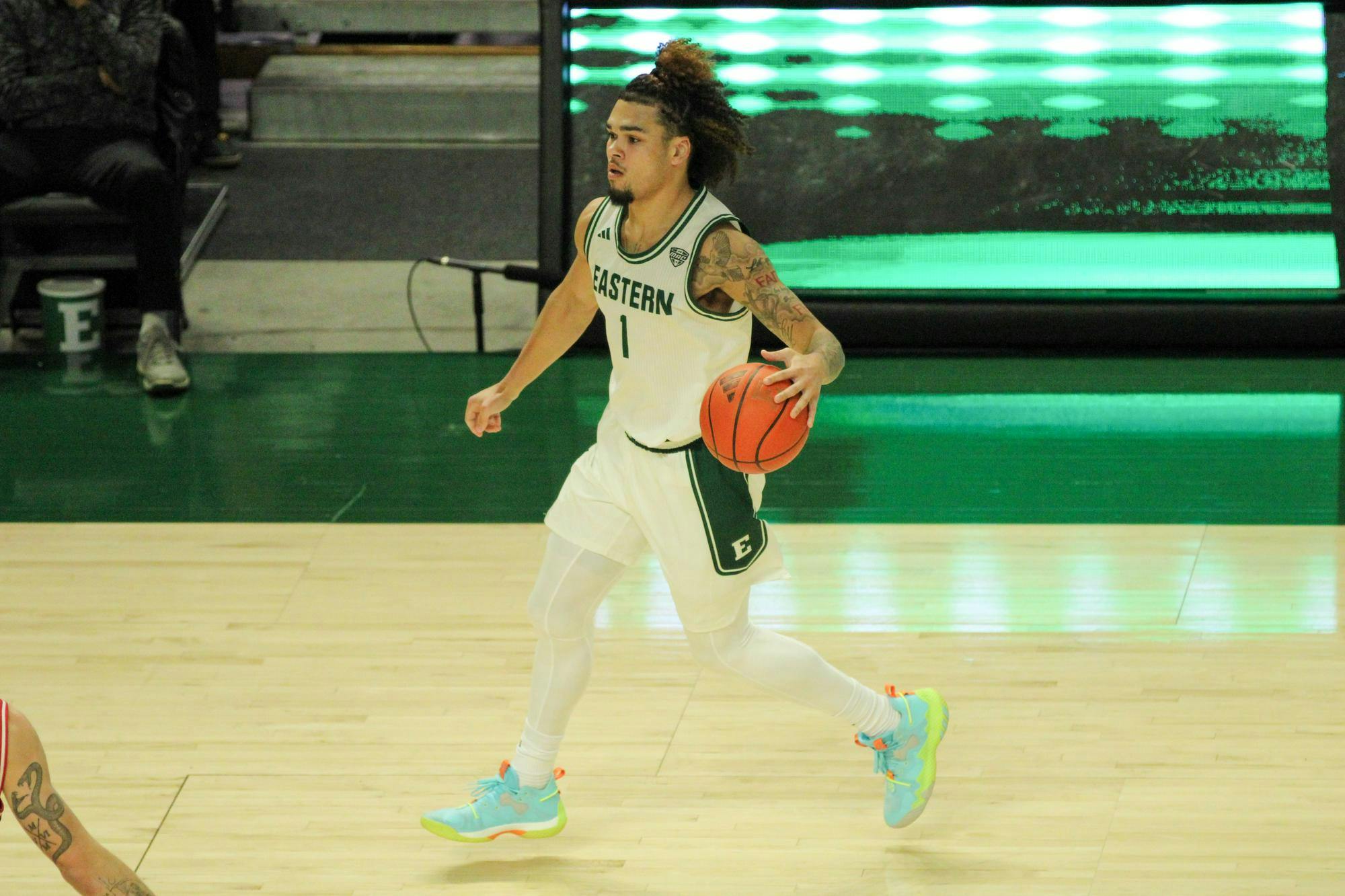 #1, in a white jersey, dribbling the basketball