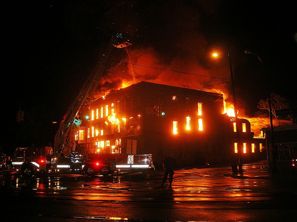 	Fire consumes the Thompson Block building in Ypsilanti&#8217;s Depot Town district early Wednesday morning. Firefighters from five local departments were called to the blaze.