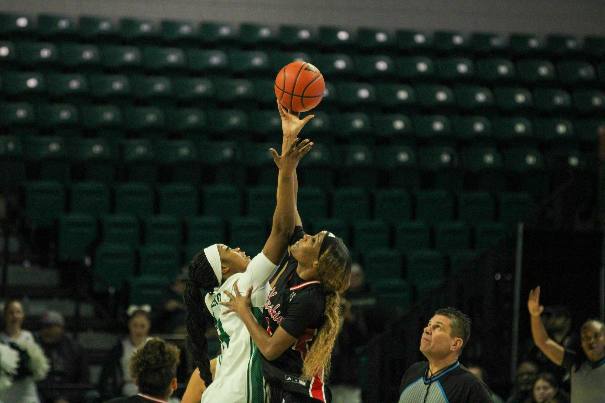 #14 Sisi Eleko taking the opening tip-off