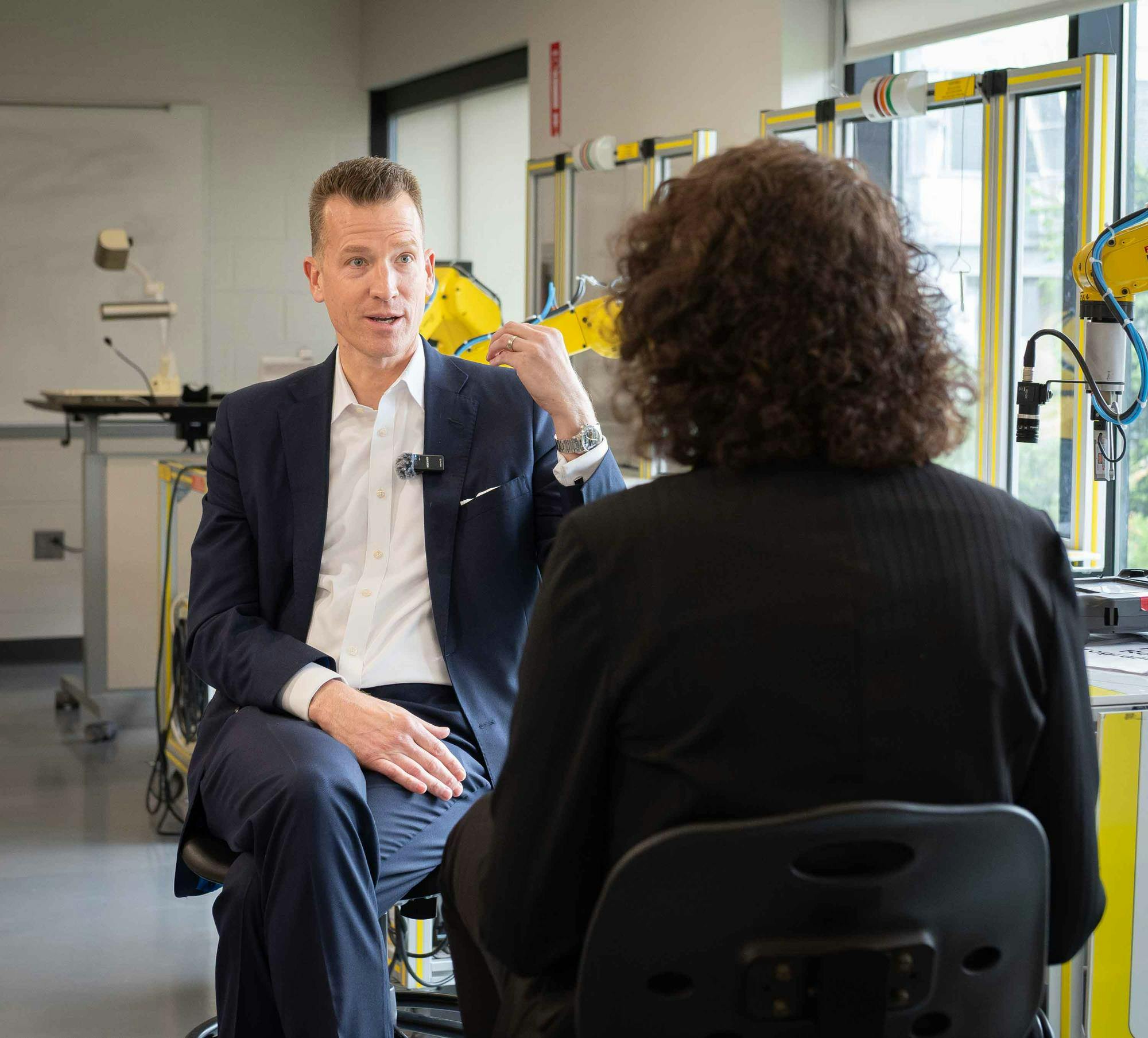 Eastern Michigan University President Brendan Kelly and Eastern Echo Reporter Laura Meriweather sit across from each other in the robotics lab in Sill Hall.
