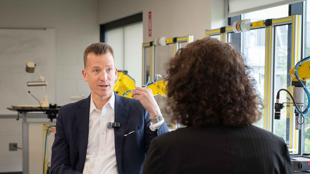 Eastern Michigan University President Brendan Kelly and Eastern Echo Reporter Laura Meriweather sit across from each other in the robotics lab in Sill Hall.