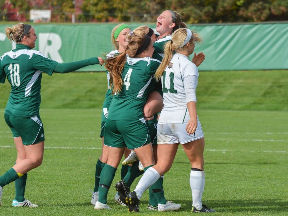 Senior, Chelsea Oddan celebrates with the EMU soccer team after scoring her second goal of the season at the EMU vs. Ohio University game on October 19th, 2014 at Scicluna Field.