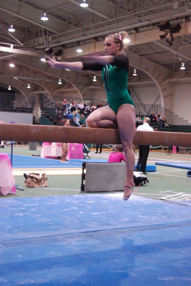 Kaylyn Millick, shown above at an earlier meet,  led the team at the championship with a score of 9.775 on the balance beam. 