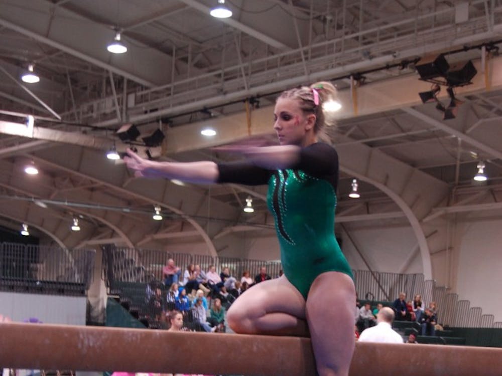 Kaylyn Millick, shown above at an earlier meet,  led the team at the championship with a score of 9.775 on the balance beam. 