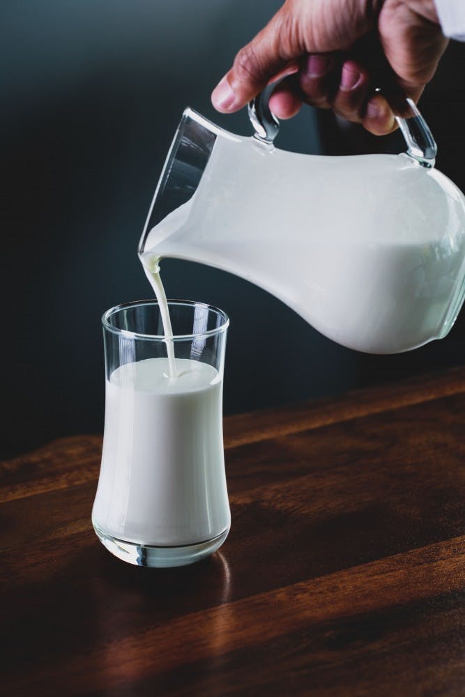 Pouring glass of milk