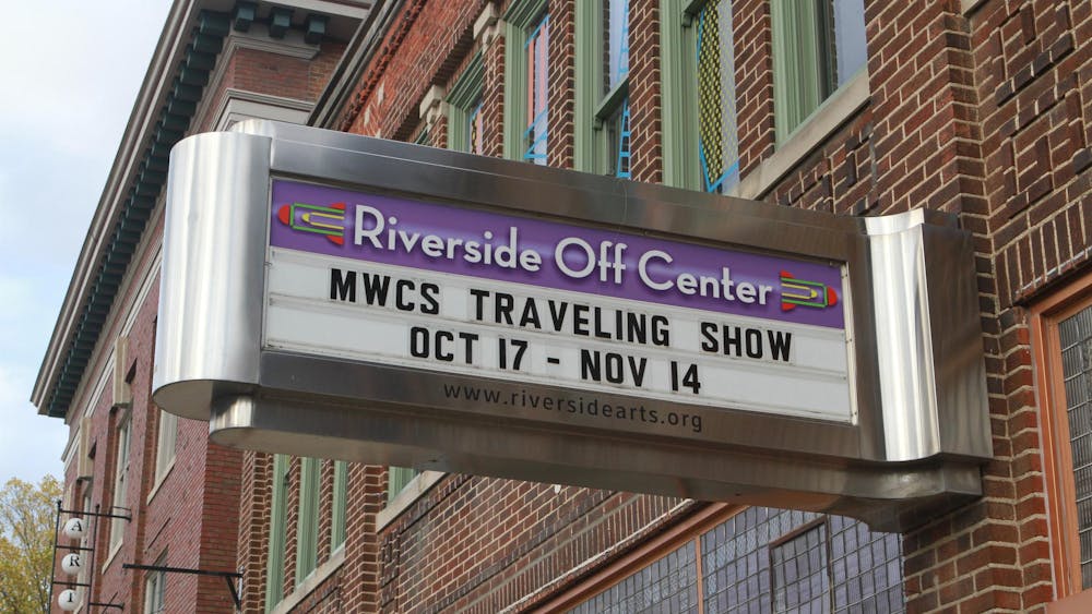 Close-up of sign outside Riverside Arts Center. The sign reads, "Riverside Off Center, MWCS Traveling Show, Oct. 17 - Nov. 14."