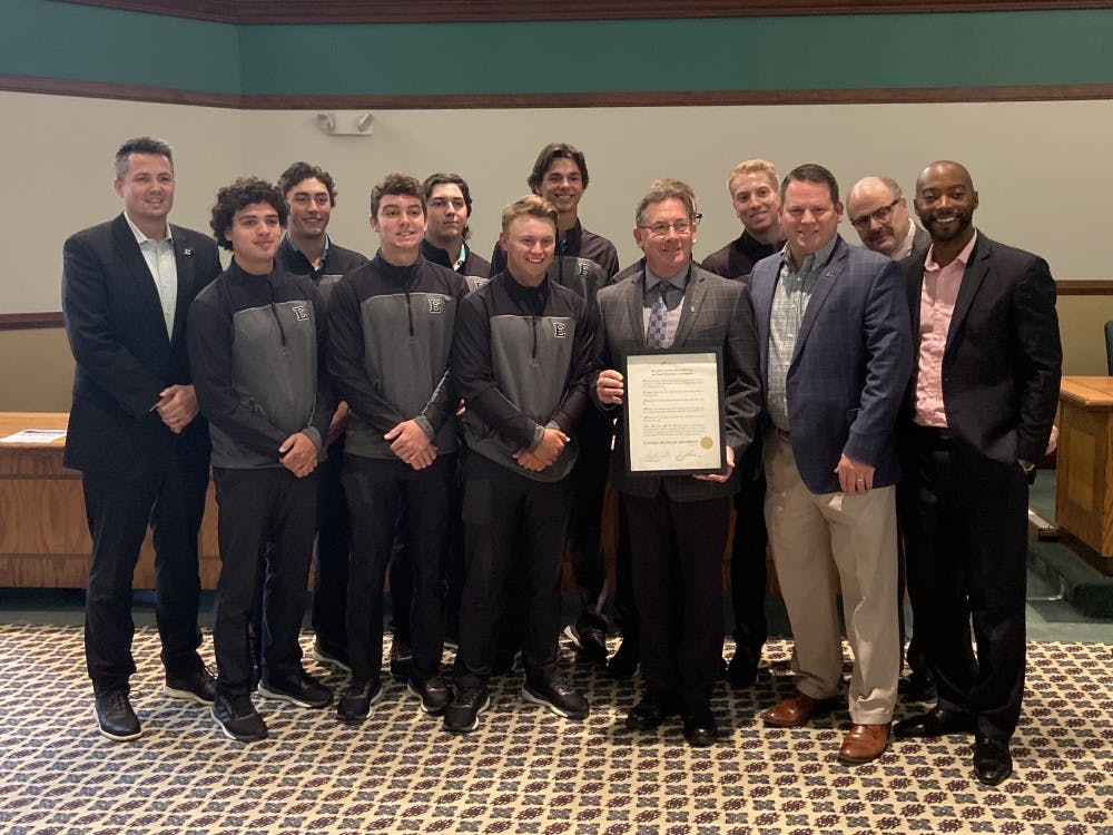 The EMU Board of Regents present the men&#x27;s golf team with a special recognition for their 2019 championship at Welch Hall.