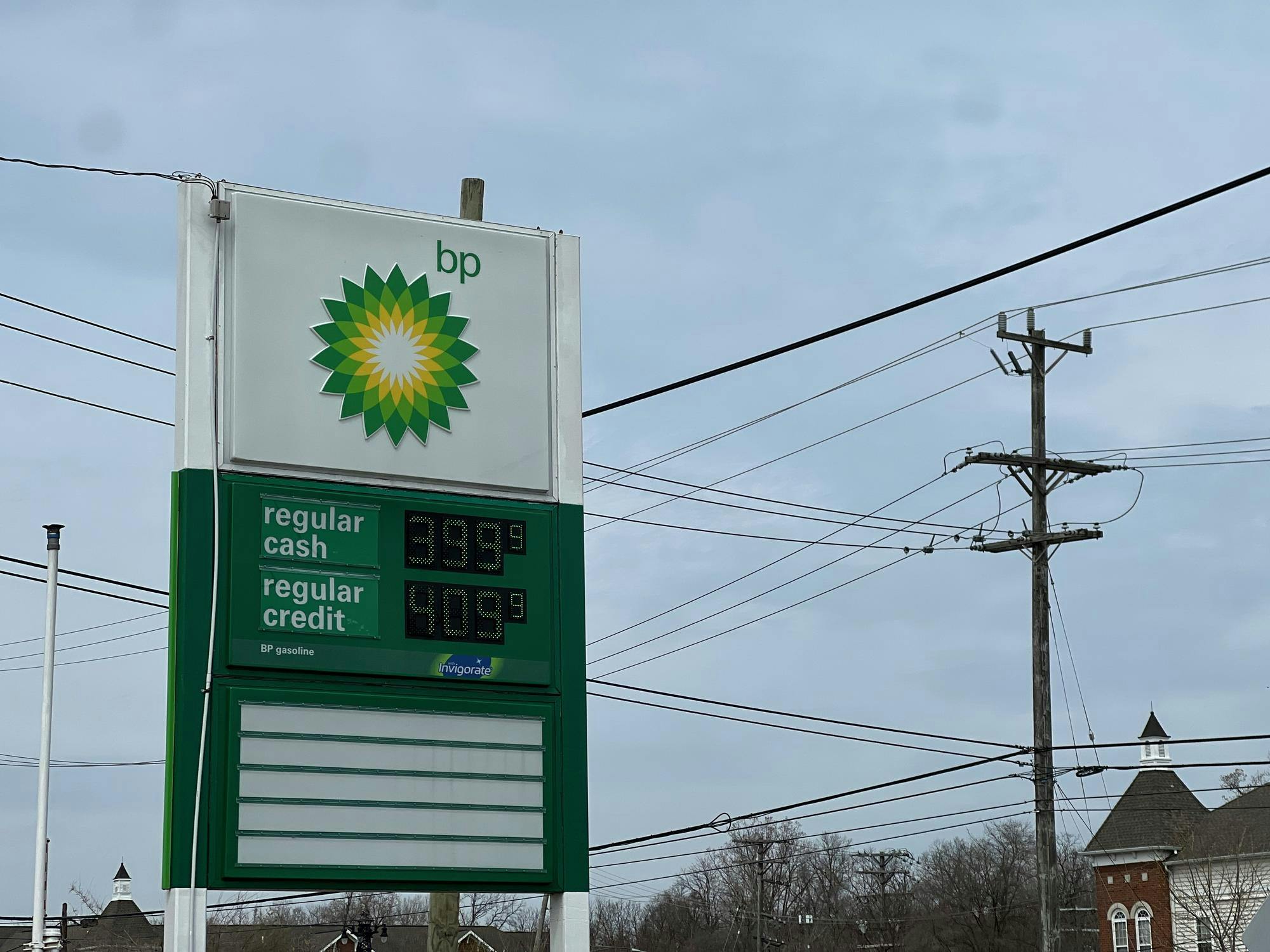 A sign shows price per gallon as $3.99 for regular fuel for cash transactions and $4.099 for credit transactions.