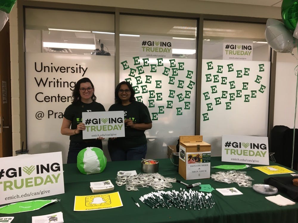 Anna Nawrocki (left) and Akshata Hiremath (right) at the college of arts and sciences giving table.